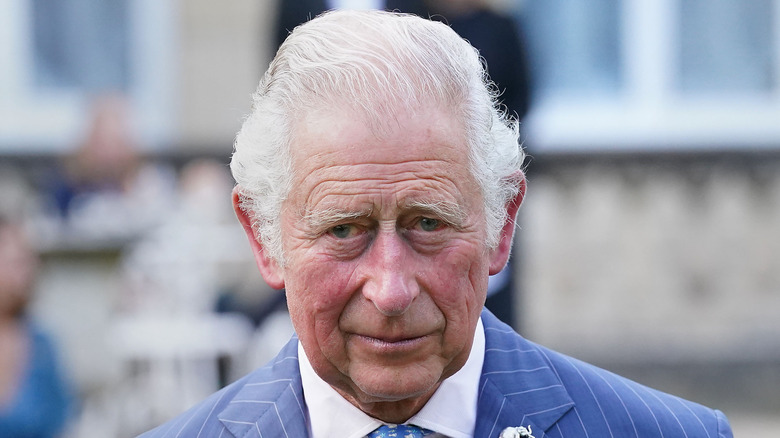Le roi Charles en costume bleu à fines rayures