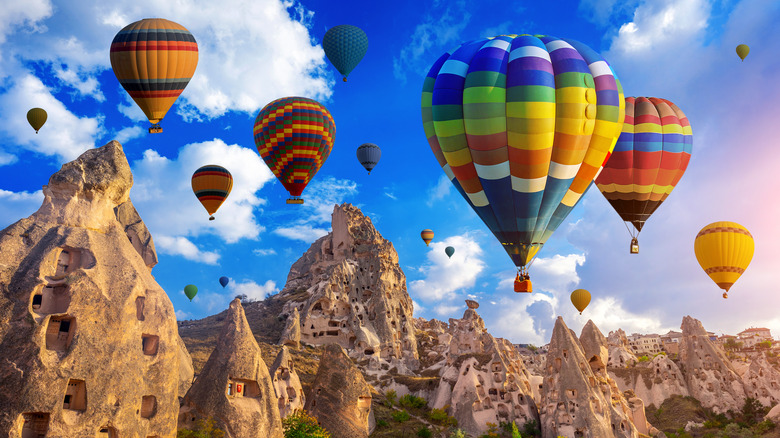 Des montgolfières flottent au-dessus des falaises de Cappadoce