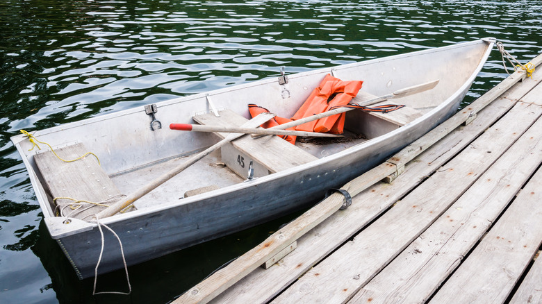 bateau avec pagaies et gilets de sauvetage à quai